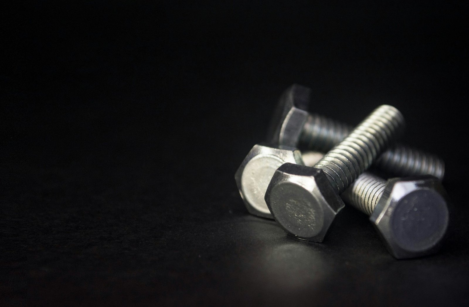 a couple of screws sitting on top of a table